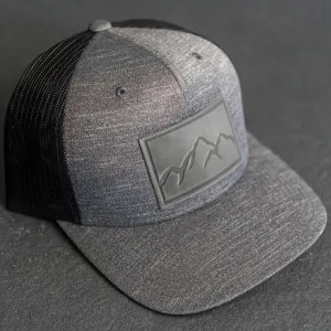 Leather Patch Performance Style Trucker Hat - Mountain Range Stamp